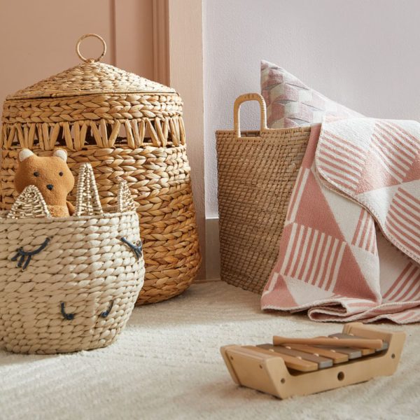 Hyacinth Nursery Hamper is handwoven with unique cutouts and a ring-topped lid to keep dirty clothes and bedding stylishly contained.