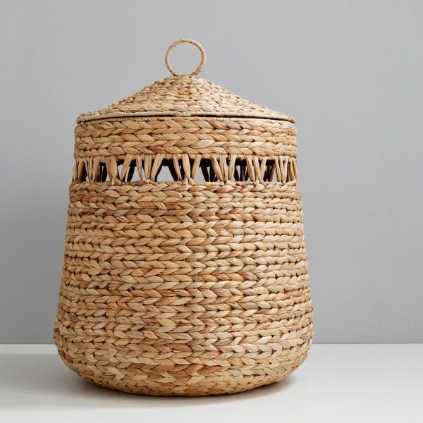 Hyacinth Nursery Hamper is handwoven with unique cutouts and a ring-topped lid to keep dirty clothes and bedding stylishly contained.